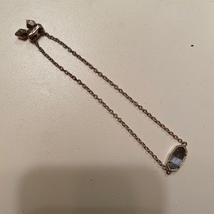 Gold kendra scott bracelet with grey “jewel”